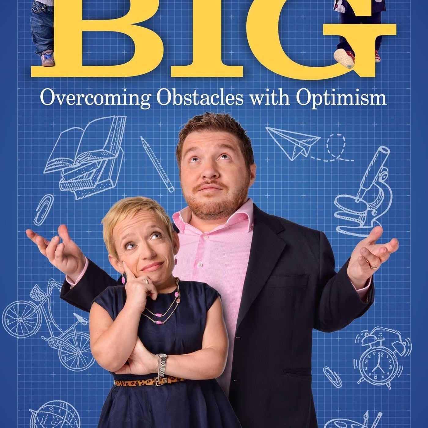 Signed copy of Think BIG paperback; two adults in front with two kids perched at the top corners on a blue grid cover.